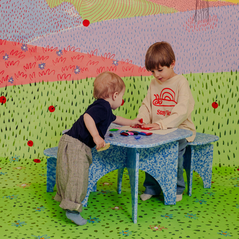 KIDS WITH M1N3 TABLE AND M1N2 STOOLS IN ARTIC BLUE BY THE MINIMONO PROJECT - BRAND FOR ECO FRIENDLY - PLAYFUL - MULTI FUNCTIONAL - SUSTAINABLE - HIGH QUALITY - CIRCULAR DESIGN FURNITURE FROM RECYCLED PLASTIC FOR BOTH ADULT AND CHILDREN MADE IN BERLIN GERMANY