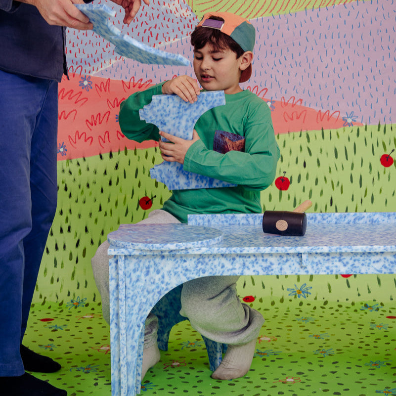 KID ASSEMBLING M1N1 STOOL ON M4N1 BENCH OR KIDS DESK IN ARTIC BLUE BY THE MINIMONO PROJECT - BRAND FOR ECO FRIENDLY - PLAYFUL - MULTI FUNCTIONAL - SUSTAINABLE - HIGH QUALITY - CIRCULAR DESIGN FURNITURE FROM RECYCLED PLASTIC FOR BOTH ADULT AND CHILDREN MADE IN BERLIN GERMANY