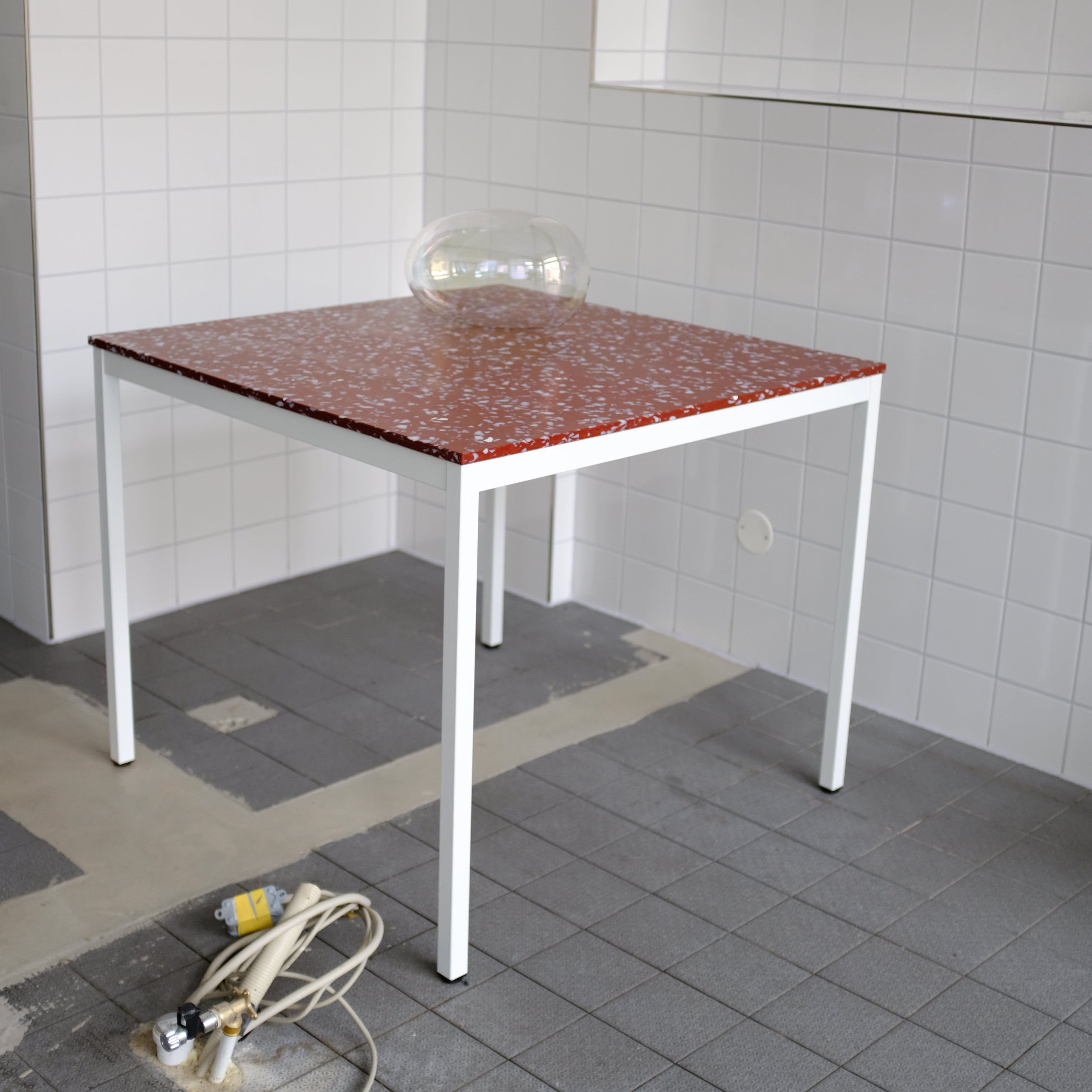 TABLE WITH RED TOP AND WHITE LEGS BY THE MINIMONO PROJECT - BRAND FOR ECO FRIENDLY - PLAYFUL - MULTI FUNCTIONAL - SUSTAINABLE - HIGH QUALITY - DESIGN FURNITURE FROM RECYCLED PLASTIC FOR BOTH ADULT AND CHILDREN MADE IN BERLIN GERMANY