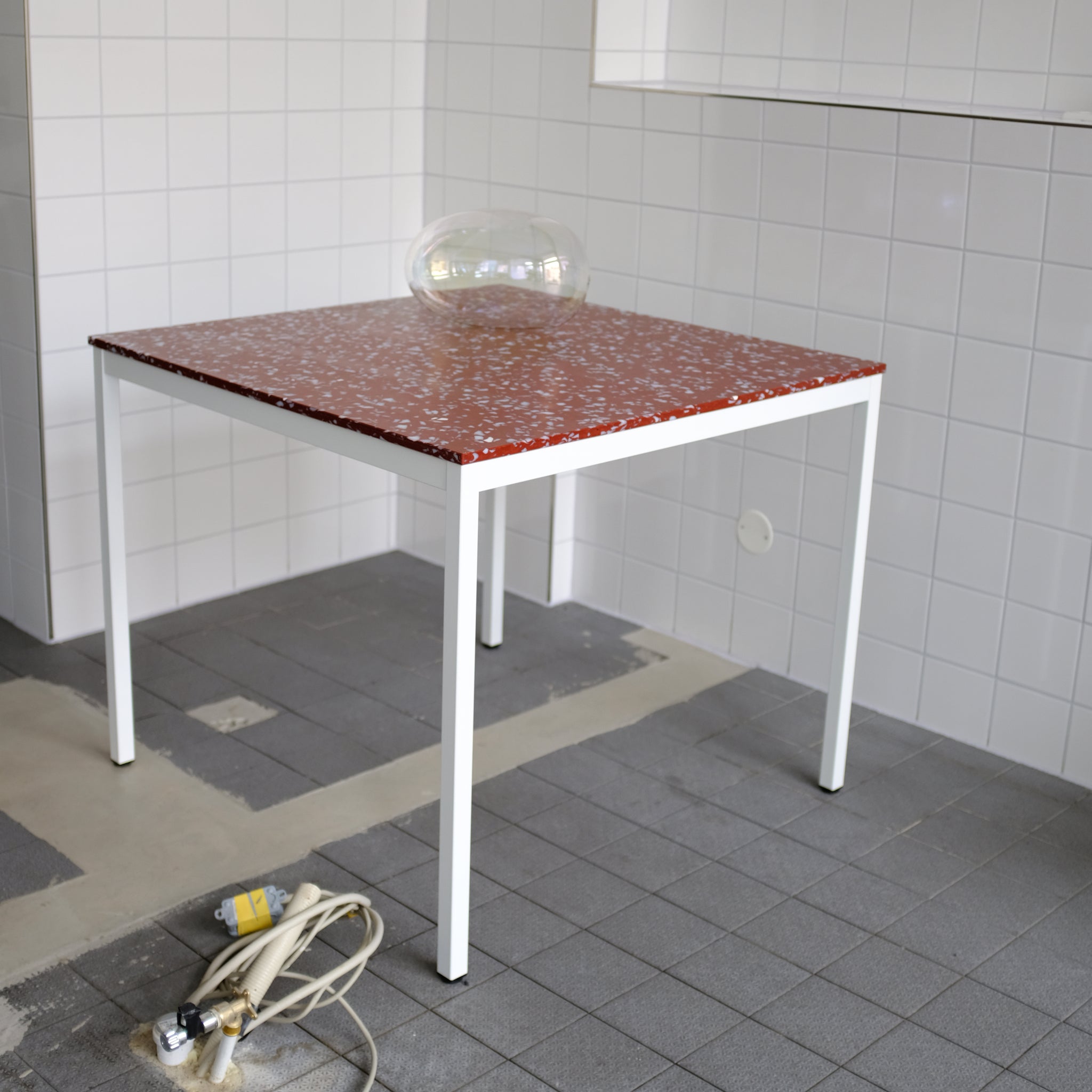 TABLE WITH RED TOP AND WHITE LEGS BY THE MINIMONO PROJECT - BRAND FOR ECO FRIENDLY - PLAYFUL - MULTI FUNCTIONAL - SUSTAINABLE - HIGH QUALITY - DESIGN FURNITURE FROM RECYCLED PLASTIC FOR BOTH ADULT AND CHILDREN MADE IN BERLIN GERMANY