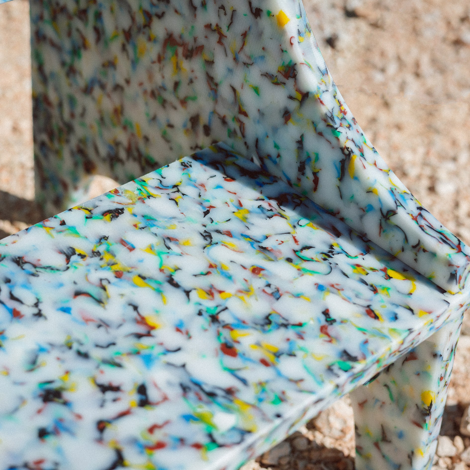 DETAIL OF COLOURFUL SMALL STEP STOOL BY THE MINIMONO PROJECT - BRAND FOR ECO FRIENDLY - PLAYFUL - MULTI FUNCTIONAL - SUSTAINABLE - HIGH QUALITY - DESIGN FURNITURE FROM RECYCLED PLASTIC FOR BOTH ADULT AND CHILDREN MADE IN BERLIN GERMANY