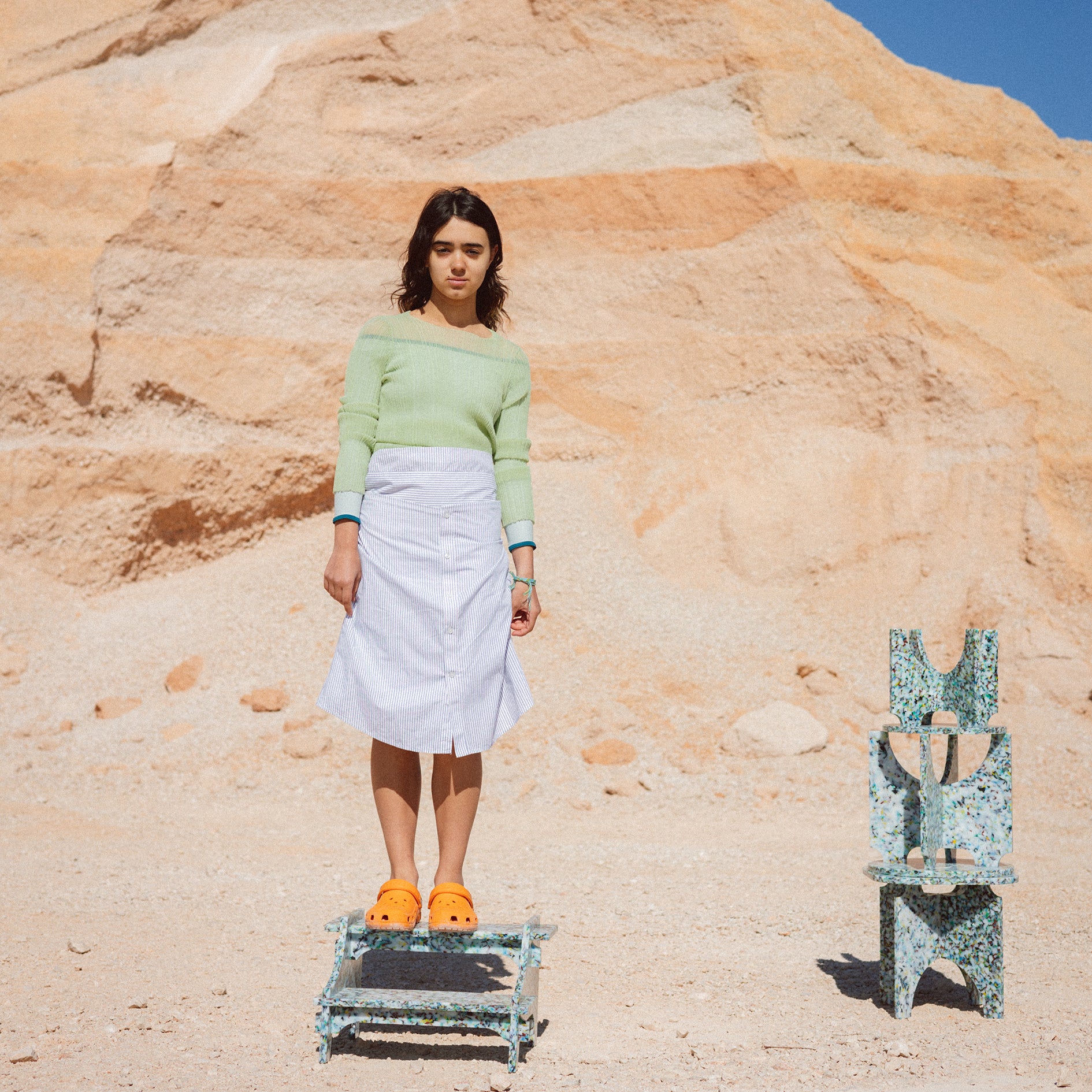 MANUELA STANDING ON COLOURFUL SMALL STEP STOOL BY THE MINIMONO PROJECT - BRAND FOR ECO FRIENDLY - PLAYFUL - MULTI FUNCTIONAL - SUSTAINABLE - HIGH QUALITY - DESIGN FURNITURE FROM RECYCLED PLASTIC FOR BOTH ADULT AND CHILDREN MADE IN BERLIN GERMANY