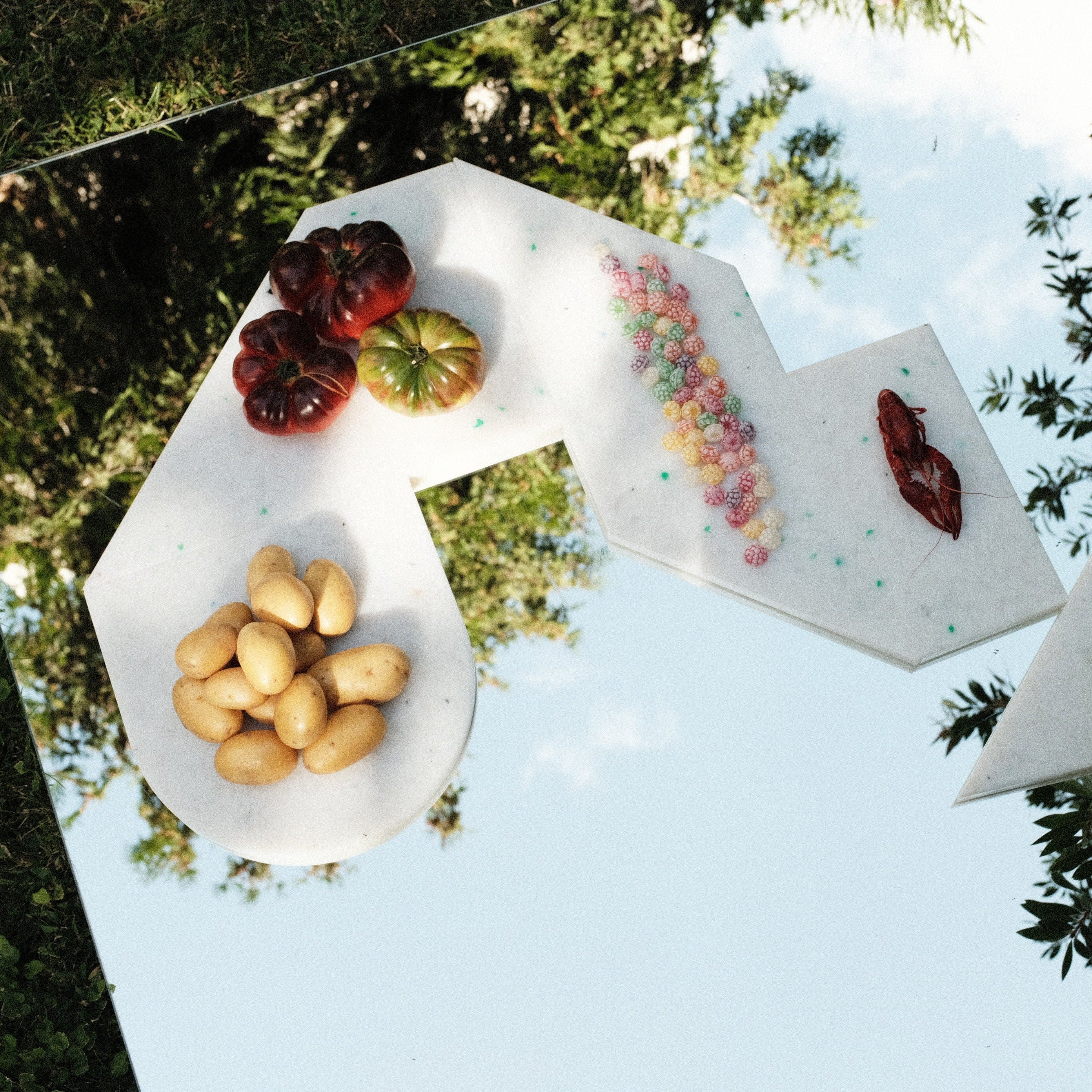 DETAIL OF SET OF WHITE CHARCUTERIE CUTTING BOARDS BY THE MINIMONO PROJECT - BRAND FOR ECO FRIENDLY - PLAYFUL - MULTI FUNCTIONAL - SUSTAINABLE - HIGH QUALITY - DESIGN FURNITURE FROM RECYCLED PLASTIC FOR BOTH ADULT AND CHILDREN MADE IN BERLIN GERMANY