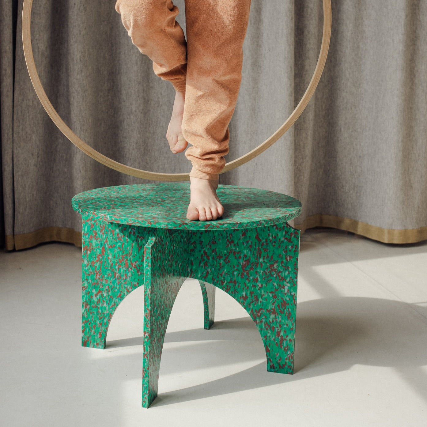 KID ON TOP OF GREEN TABLE BY THE MINIMONO PROJECT - BRAND FOR ECO FRIENDLY - PLAYFUL - MULTI FUNCTIONAL - SUSTAINABLE - HIGH QUALITY - DESIGN FURNITURE FROM RECYCLED PLASTIC FOR BOTH ADULT AND CHILDREN MADE IN BERLIN GERMANY